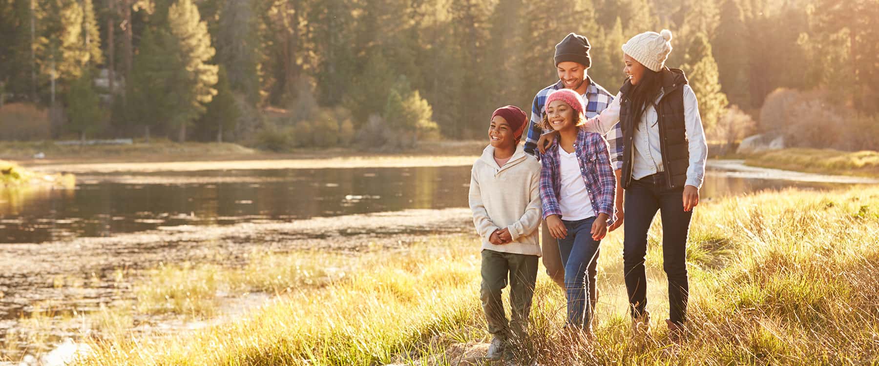Family enjoying time together by a lake